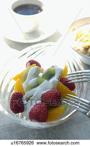 Stock Photograph - Fruit bowl with yogurt on top. Fotosearch