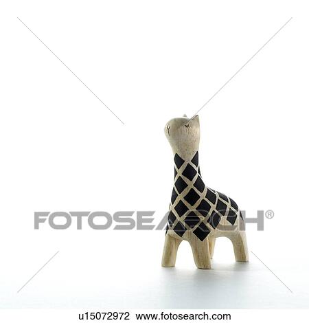 Stock Image - Giraffe figurine on white background, copy space. Fotosearch
