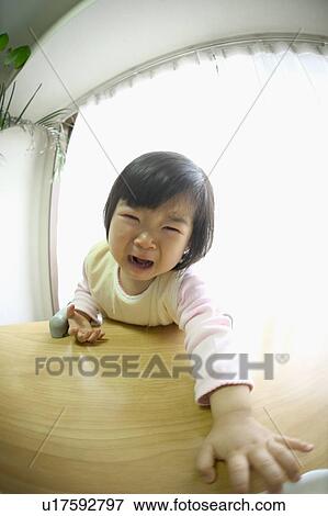 Girl crying at desk, looking at camera, fish-eye lens View Large Photo Image Stock Photo - Girl crying at desk, looking at camera, fish-eye lens. Fotosearch