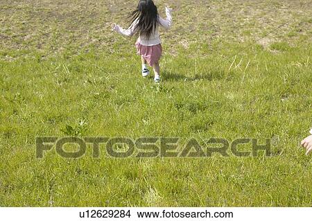 Picture - Girl running down the hill. Fotosearch
