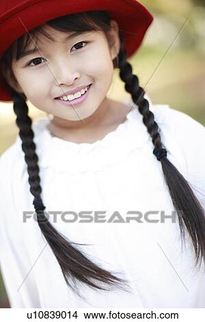Girl with a red hat View Large Photo Image Picture - Girl with a red hat. Fotosearch