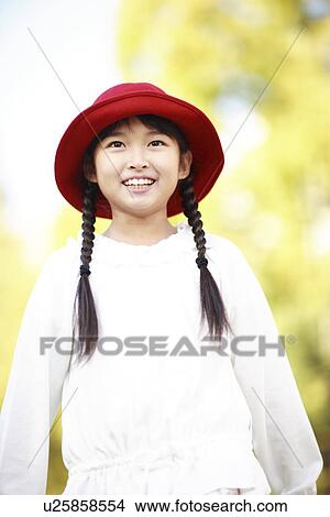 Girl with a red hat View Large Photo Image Picture - Girl with a red hat. Fotosearch