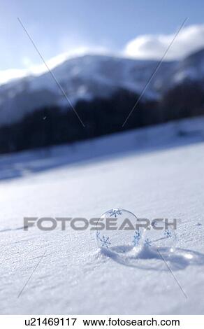 Stock Photo - Glass balls with snowflakes on snow. Fotosearch