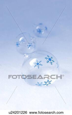 Stock Photograph - Glass balls with snowflakes on snow. Fotosearch