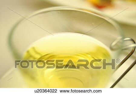 Stock Image - Glass of herbal tea, close up. Fotosearch