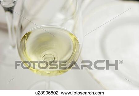 Stock Image - Glass of white wine, close up. Fotosearch