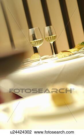 Stock Image - Glasses of wine on table, differential focus. Fotosearch