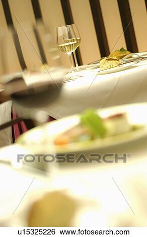 Stock Photograph - Glasses of wine on table, differential focus. Fotosearch
