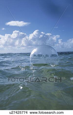 Picture - Globe beach ball floating on water. Fotosearch