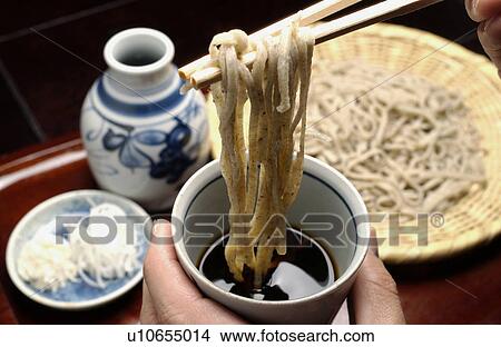 Hand holding Soba noodles with chopsticks View Large Photo Image Picture - Hand holding Soba noodles with chopsticks. Fotosearch