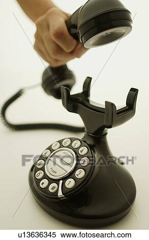 Hand holding telephone receiver, white background View Large Photo Image Stock Photography - Hand holding telephone receiver, white background. Fotosearch