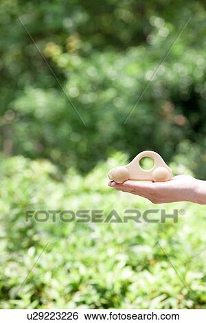 Stock Photograph - Hand holding toy car. Fotosearch