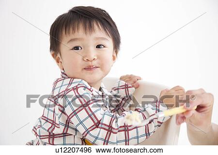 Hand of woman feeding boy a piece of cake View Large Photo Image Stock Photograph - Hand of woman feeding boy a piece of cake. Fotosearch