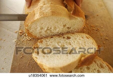 Hand slicing bread View Large Photo Image Stock Image - Hand slicing bread. Fotosearch