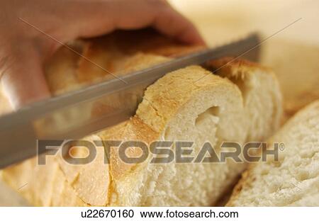 Hand slicing bread View Large Photo Image Stock Image - Hand slicing bread. Fotosearch