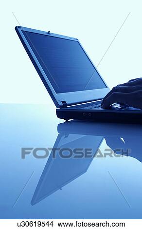 Hand using laptop, blue background View Large Photo Image Picture - Hand using laptop, blue background. Fotosearch