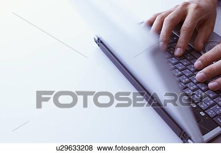 Hand using laptop, white background View Large Photo Image Stock Photo - Hand using laptop, white background. Fotosearch