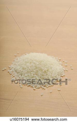 Picture - Heap of raw rice. Fotosearch