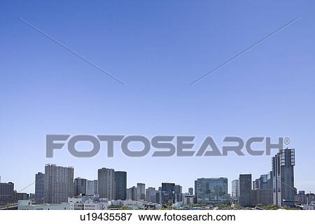 Stock Photo - High rise buildings under sky, copy space, Tokyo prefecture, Japan. Fotosearch
