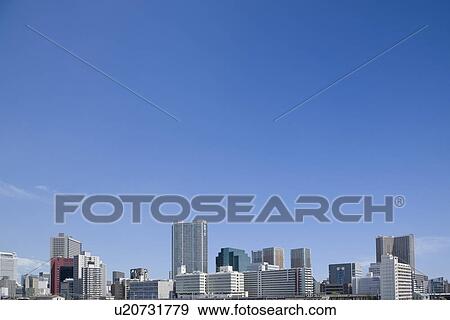 Stock Photo - High rise buildings under sky, copy space, Tokyo prefecture, Japan. Fotosearch