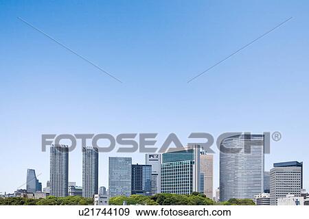 Stock Photo - High rise buildings under sky, copy space, Tokyo prefecture, Japan. Fotosearch