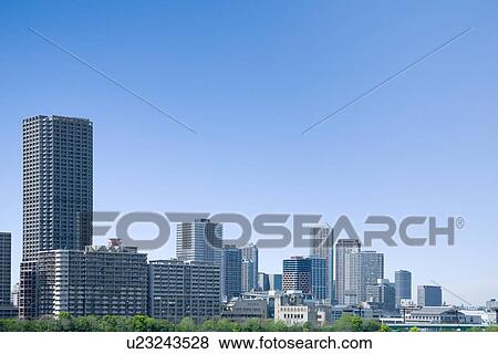 Stock Photo - High rise buildings under sky, copy space, Tokyo prefecture, Japan. Fotosearch