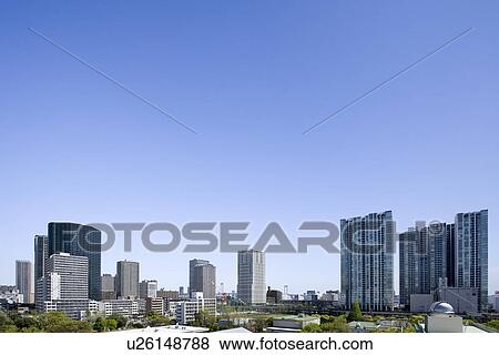 Stock Photo - High rise buildings under sky, copy space, Tokyo prefecture, Japan. Fotosearch