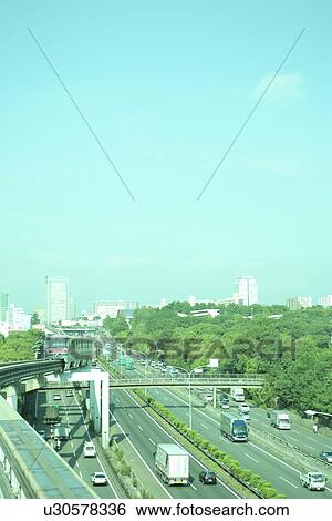 Stock Photograph - Highway and office buildings, toned image, copy space, Suita city, Osaka prefecture, Japan. Fotosearch
