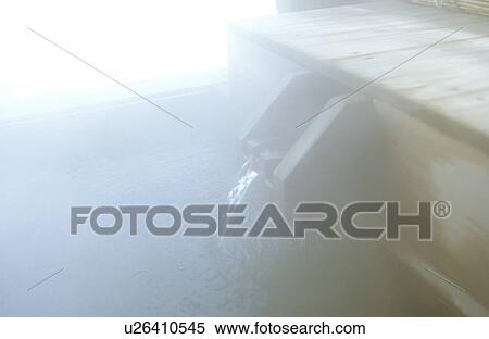 Stock Photography - Hot water pouring into bathtub, close up, soft focus. Fotosearch