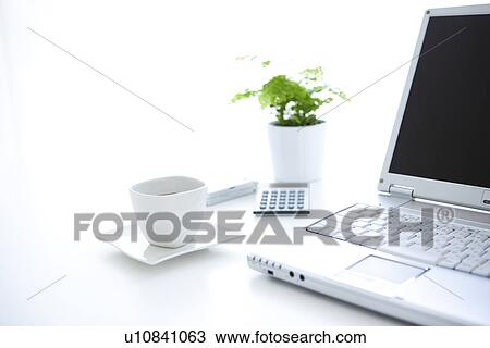 Laptop and cup of coffee on desk in office, white background View Large Photo Image Stock Image - Laptop and cup of coffee on desk in office, white background. Fotosearch