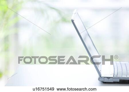 Stock Photo - Laptop on desk in office, differential focus. Fotosearch
