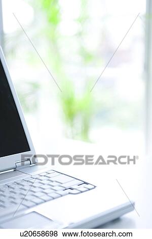 Stock Photo - Laptop on desk in office, differential focus. Fotosearch