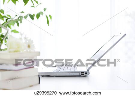 Stock Image - Laptop on desk in office. Fotosearch