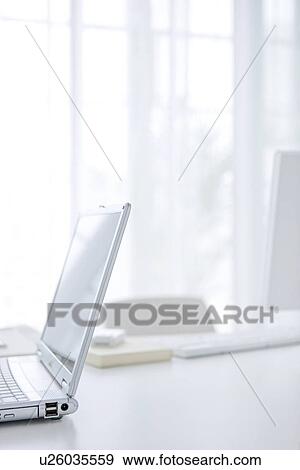 Stock Photo - Laptop on desk in office. Fotosearch