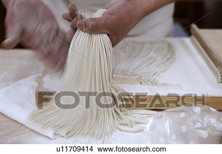 Picture - Man making Soba noodles, blurred motion. Fotosearch