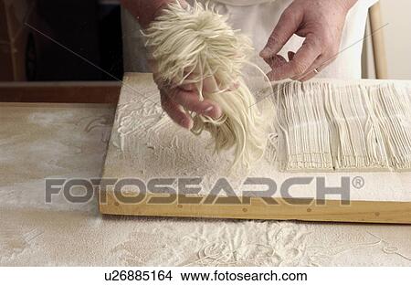 Picture - Man making Soba noodles, blurred motion. Fotosearch