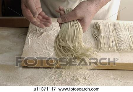 Stock Photo - Man making Soba noodles, blurred motion. Fotosearch