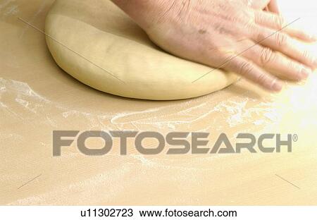Stock Image - Man making Soba noodles, making dough. Fotosearch