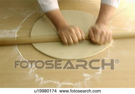 Picture - Man making Soba noodles, rolling dough, blurred motion. Fotosearch