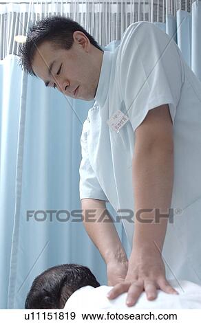 Stock Photo - Massage therapist massaging man's back. Fotosearch