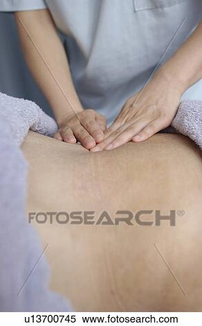 Massage therapist massaging man's back, close up View Large Photo Image Stock Photography - Massage therapist massaging man's back, close up. Fotosearch
