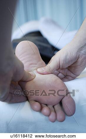 Massage therapist massaging man's foot, close up View Large Photo Image Stock Image - Massage therapist massaging man's foot, close up. Fotosearch