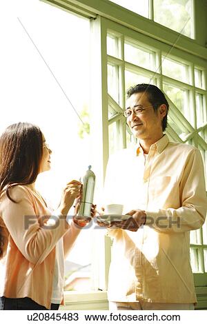 Stock Image - Mature couple drinking coffee. Fotosearch