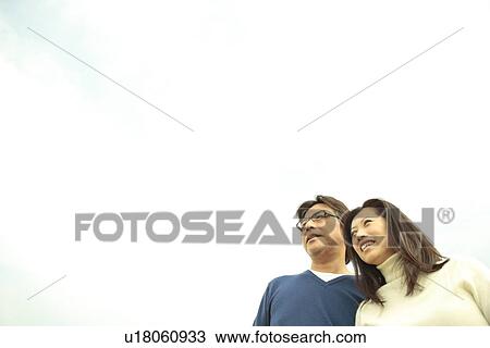 Stock Image - Mature couple, Low angle view. Fotosearch