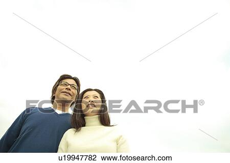 Mature couple, Low angle view View Large Photo Image Stock Image - Mature couple, Low angle view. Fotosearch