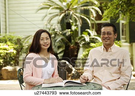 Mature couple relaxing at backyard View Large Photo Image Stock Image - Mature couple relaxing at backyard. Fotosearch