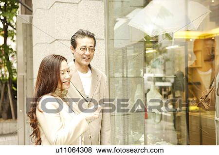 Stock Photo - Mature couple window shopping. Fotosearch