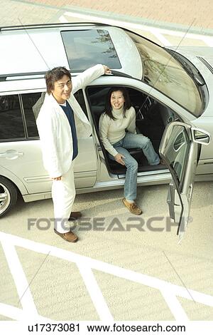 Stock Image - Mature couple with car. Fotosearch