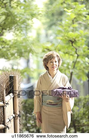 Mature woman in Kimono holding gift, Kyoto city, Kyoto prefecture, Japan View Large Photo Image Stock Photograph - Mature woman in Kimono holding gift, Kyoto city, Kyoto prefecture, Japan. Fotosearch
