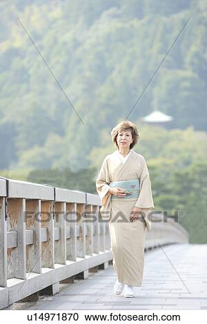 Mature woman in Kimono walking on bridge, Kyoto city, Kyoto prefecture, Japan View Large Photo Image Stock Image - Mature woman in Kimono walking on bridge, Kyoto city, Kyoto prefecture, Japan. Fotosearch